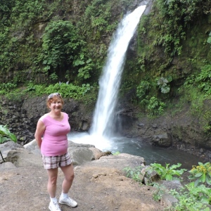 Lady Yankee poses by a waterfall, which temporarily becomes the second most beautiful thing in the scenery.